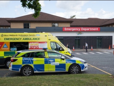 emergency department with ambulance and police car parked outside
