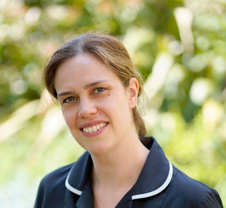 Woman wearing black pharmacist uniform