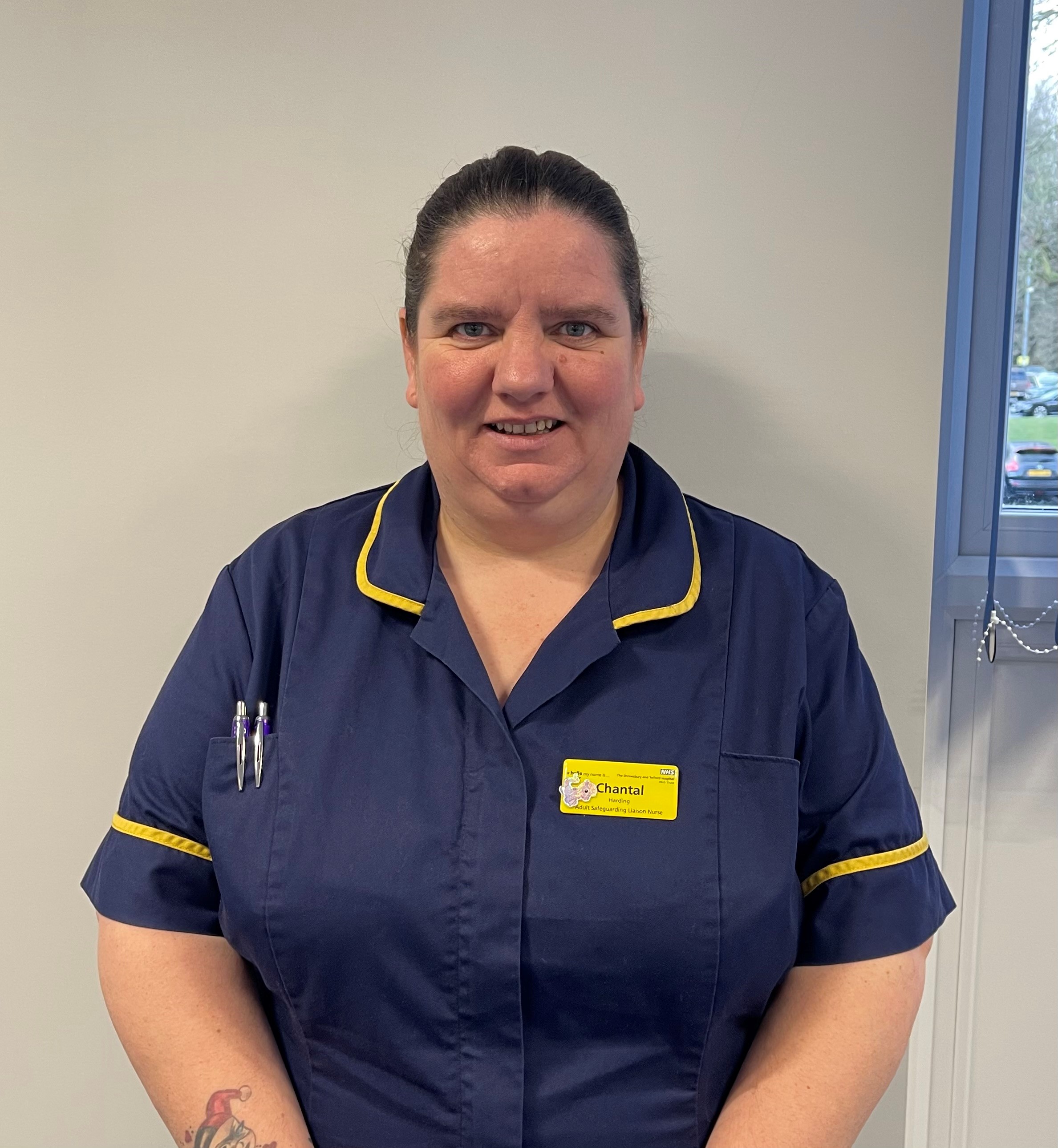 Women wearing navy blue nurse uniform with a yellow trim.